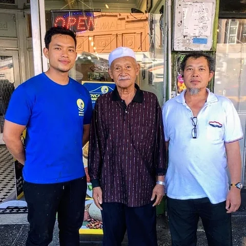 Three generations of the Uncle Man's family standing outside the restaurant